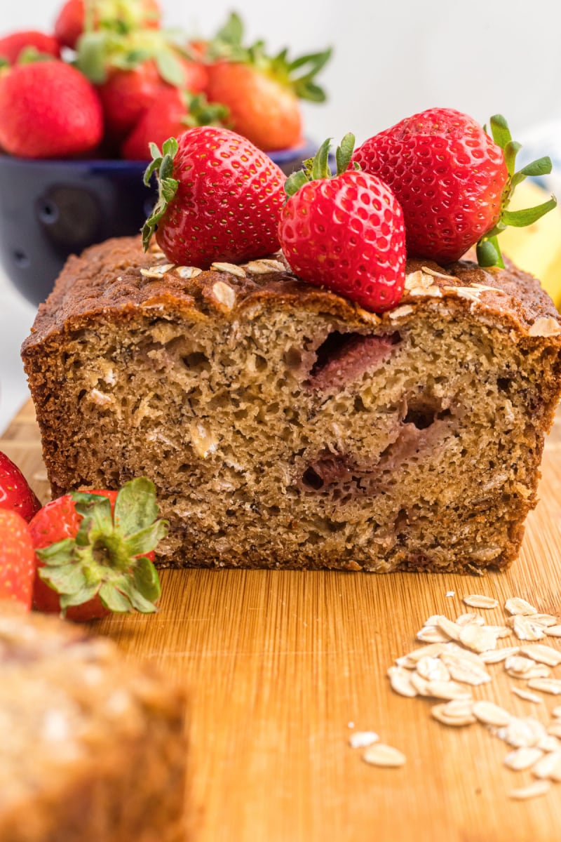 loaf of strawberry oatmeal banana bread cut open to see inside