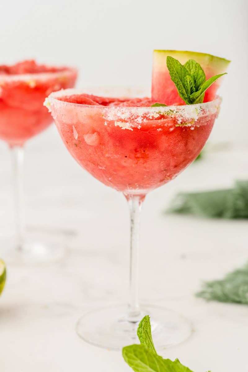 two watermelon mint margaritas garnished with mint and watermelon