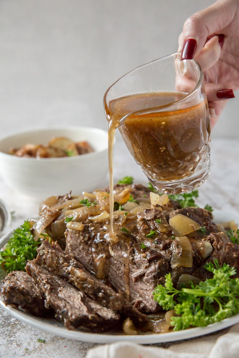 Pouring gravy on Black Forest Pot Roast