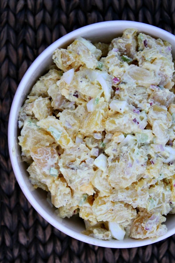 White Bowl of All American Potato Salad set on a woven placemat