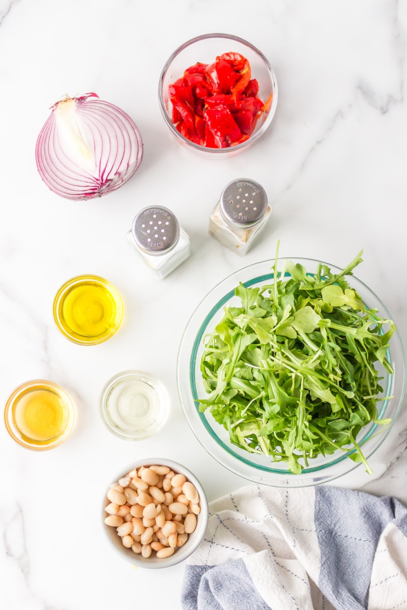 ingredients displayed for making arugula, white bean and roasted red pepper salad