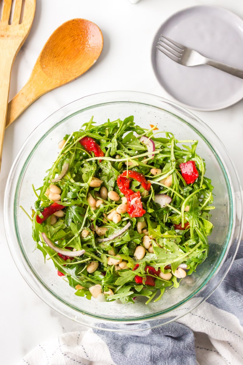 arugula, white bean and roasted red pepper salad in a bowl