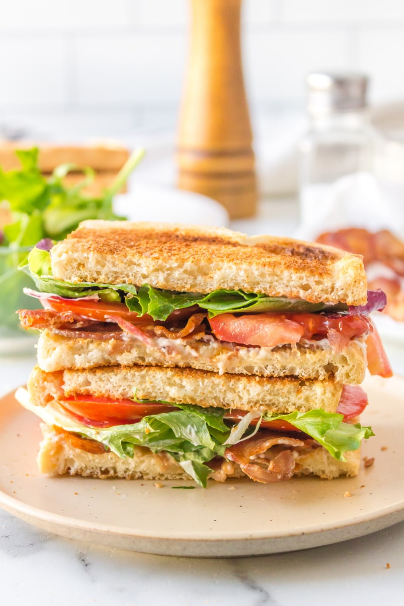 best blt sandwich cut in half and stacked on plate