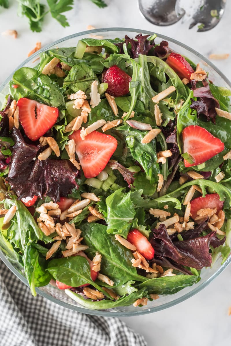 green salad with strawberries and sugared almonds