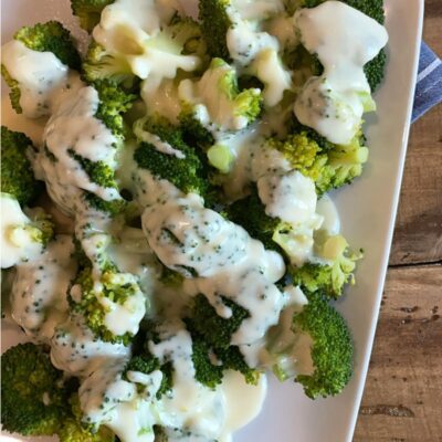 broccoli on a plate with cheese sauce