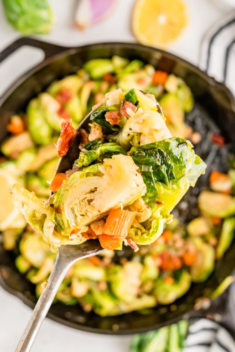 spoonful of brussels sprouts over a skillet