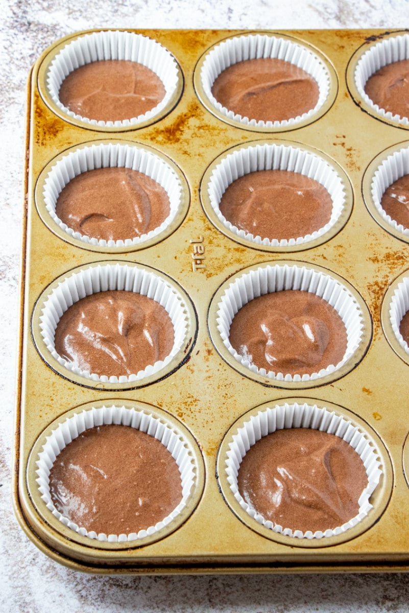 chocolate ganache cupcakes in a muffin tin ready for the oven