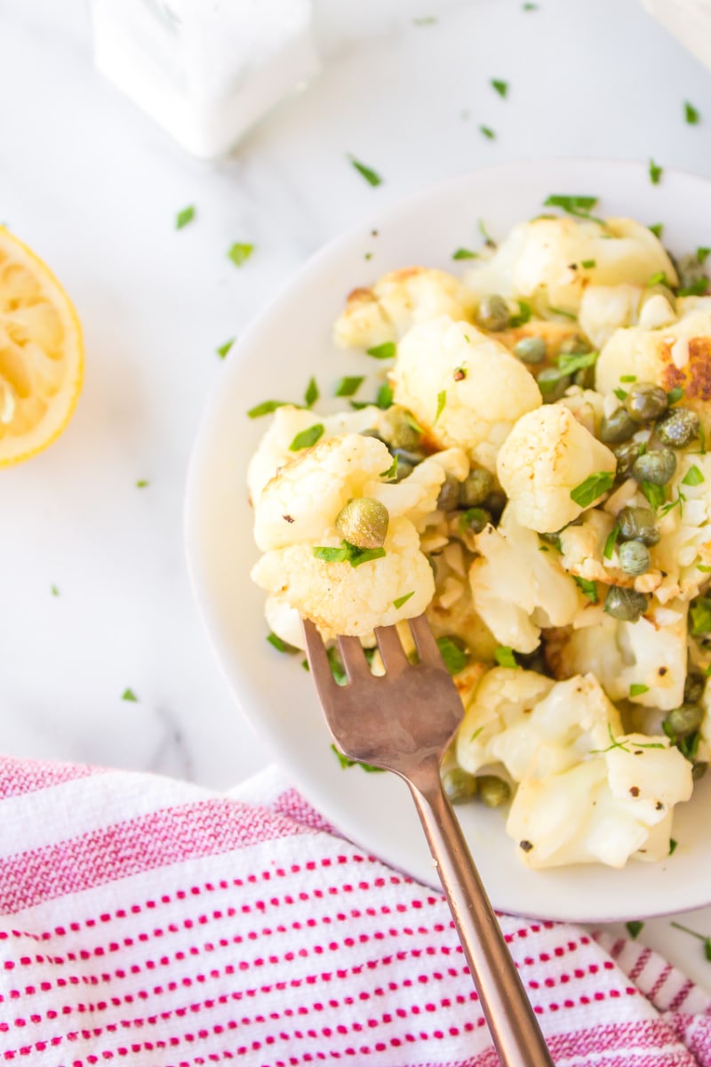 cauliflower with capers in a dish with a fork