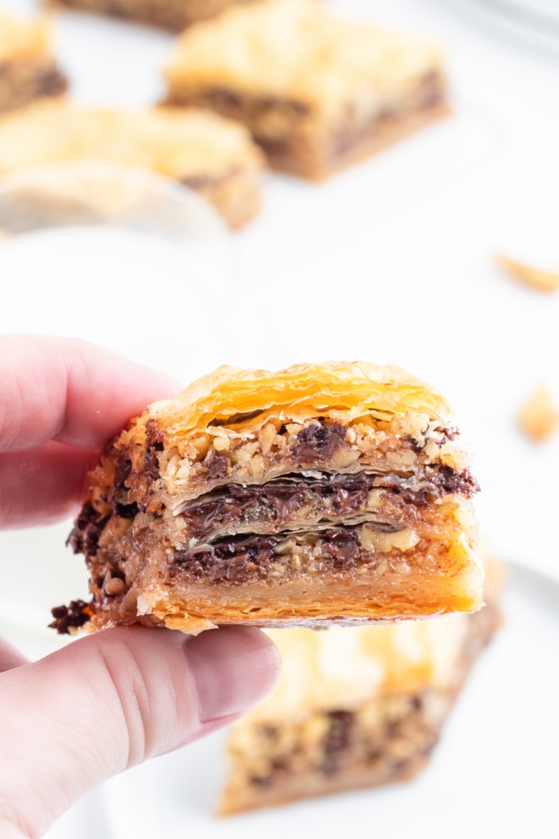 hand holding piece of baklava