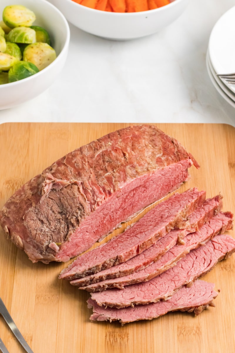 Classic Corned Beef recipe from RecipeGirl.com #classic #cornedbeef #recipe #RecipeGirl Classic Corned Beef sliced on a cutting board
