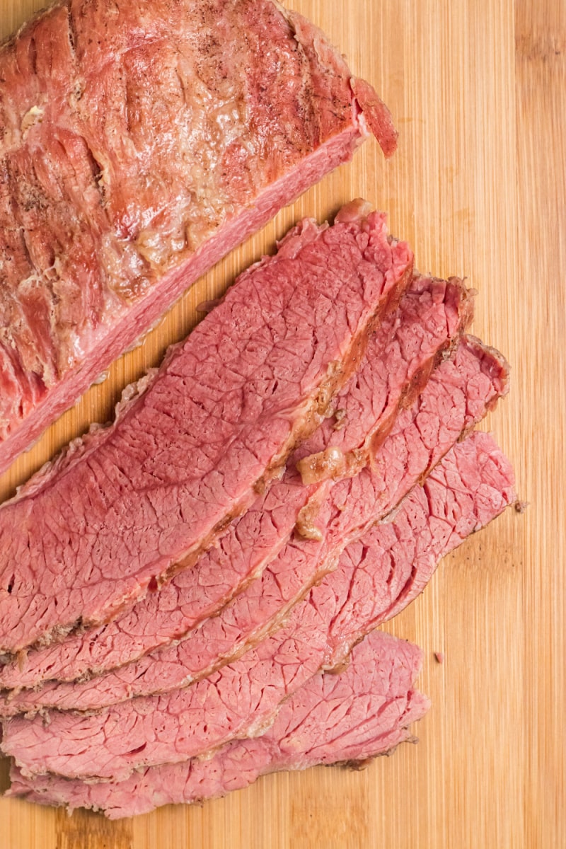 Classic Corned Beef cut into slices on a cutting board