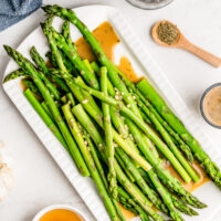 drunken asparagus on a white plate