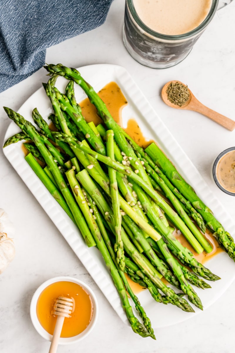 drunken asparagus on a white plate