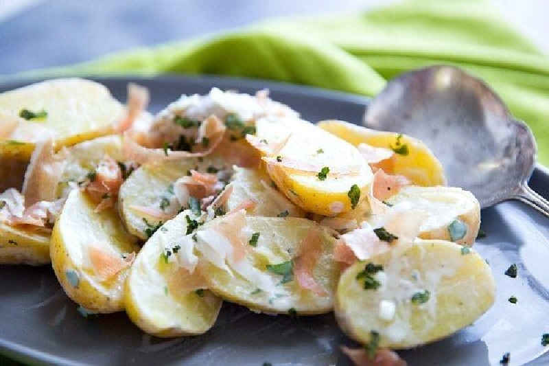Fingerling Potato and Prosciutto Salad recipe from RecipeGirl.com #fingerlingpotatoes #prosciutto #salad #recipe #RecipeGirl potato salad on a blue plate