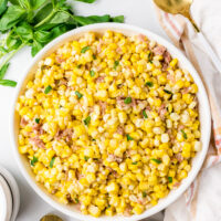 fresh corn with prosciutto basil butter in bowl