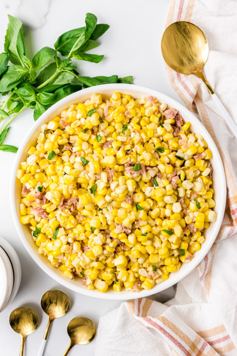 fresh corn with prosciutto basil butter in bowl