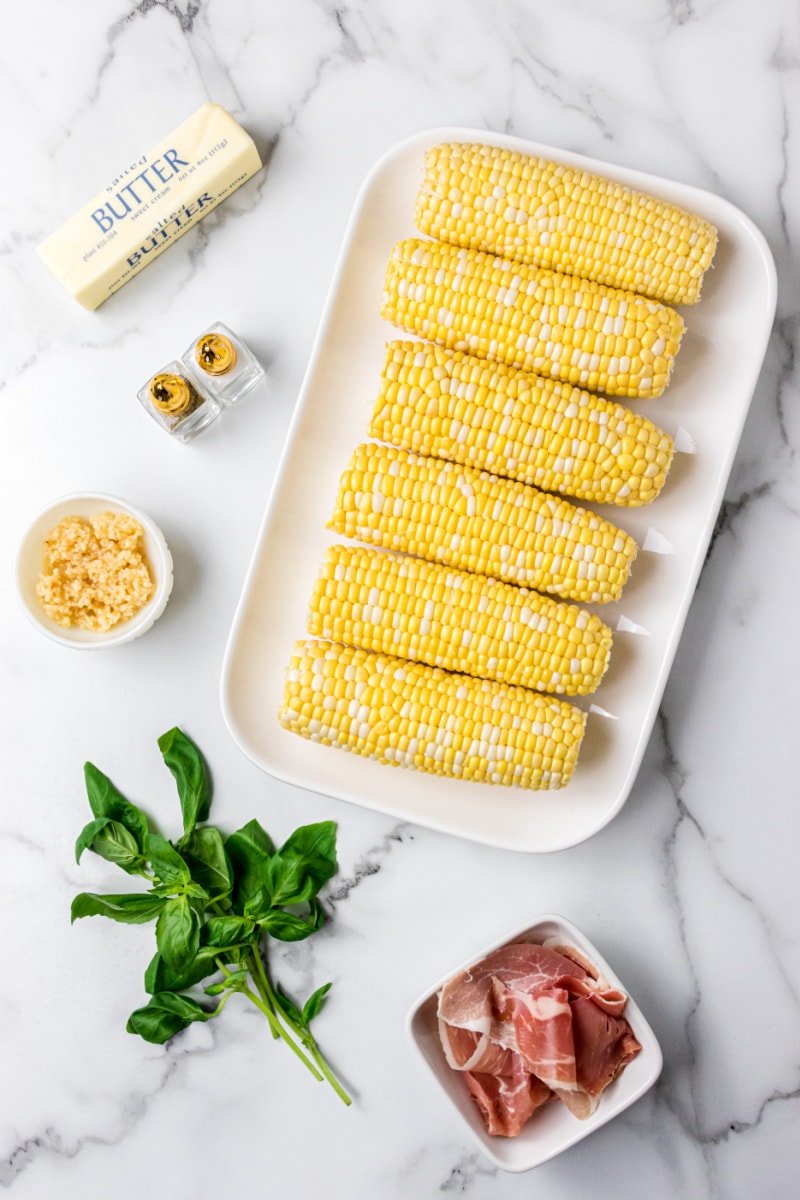 ingredients displayed for making fresh corn with prosciutto basil butter