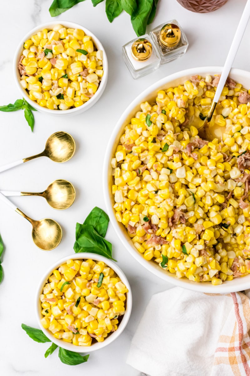 big bowl and servings of fresh corn with prosciutto basil butter