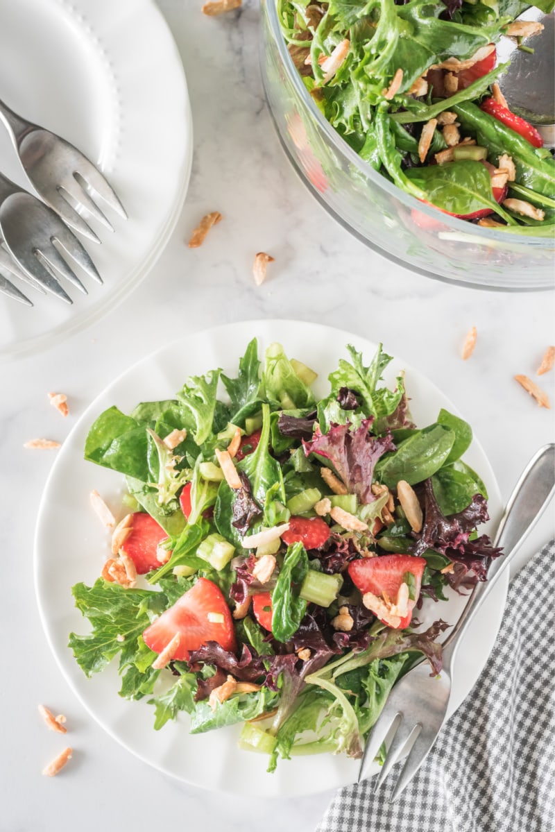 serving plate of green salad with strawberries