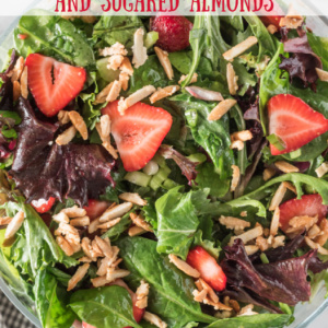 pinterest image for green salad with strawberries and sugared almonds