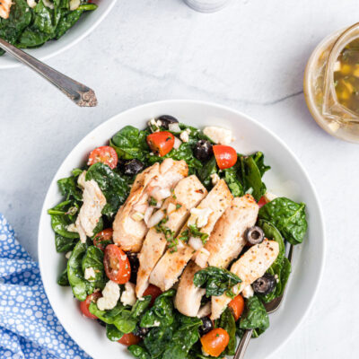 plate of spinach salad with chicken
