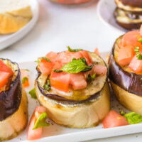 grilled eggplant open faced sandwiches on platter