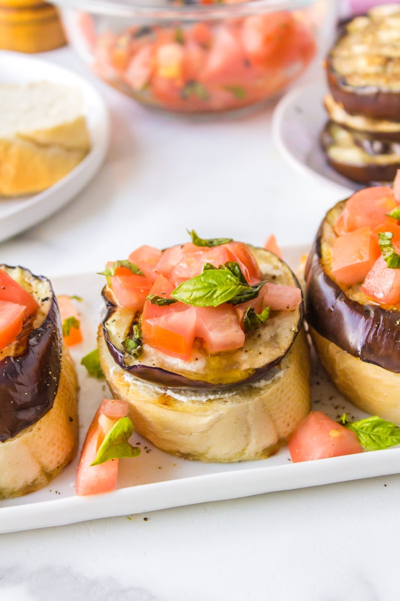 grilled eggplant open faced sandwiches on platter