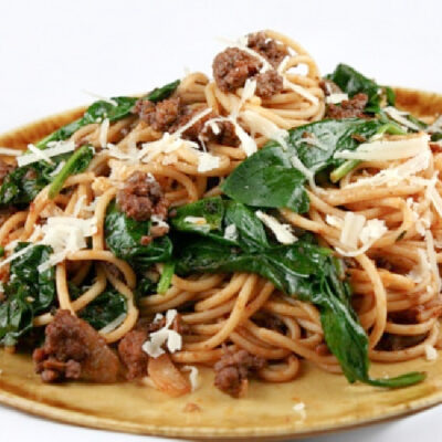 lamb spaghetti with spinach on a plate