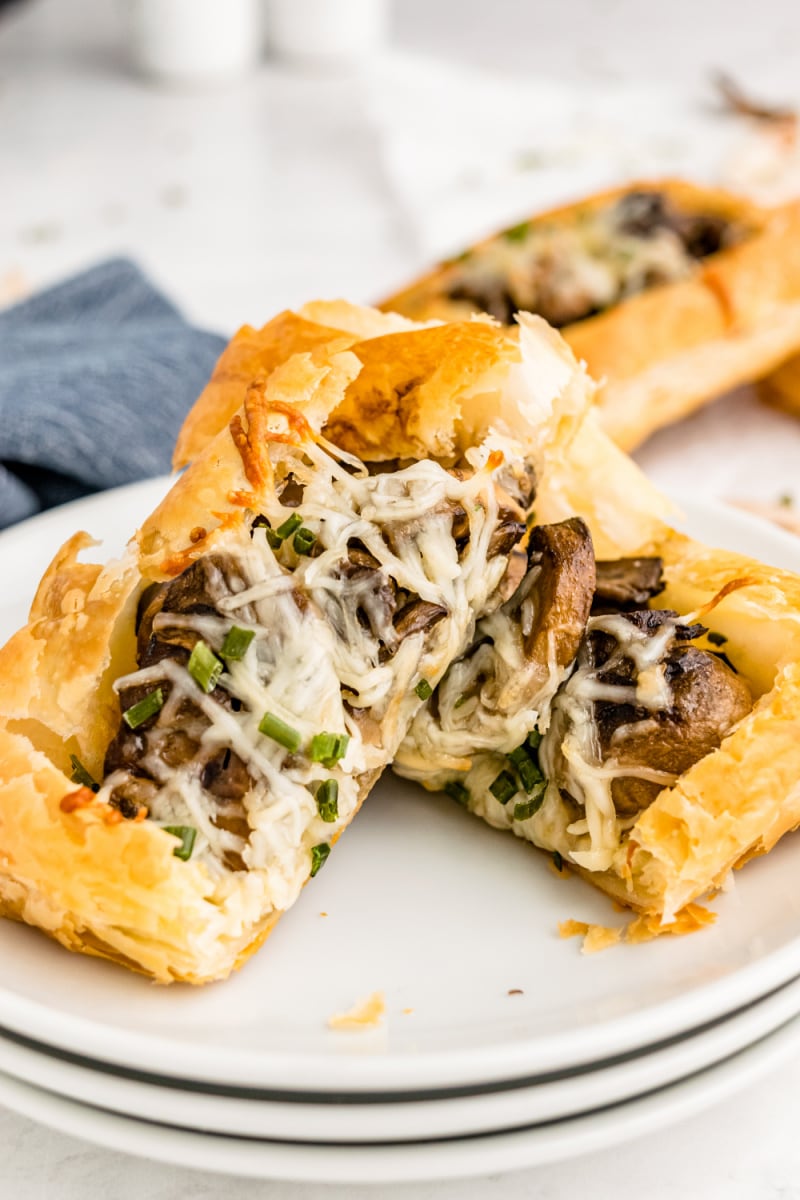 mushroom and cheese puff pastry tart cut into two pieces