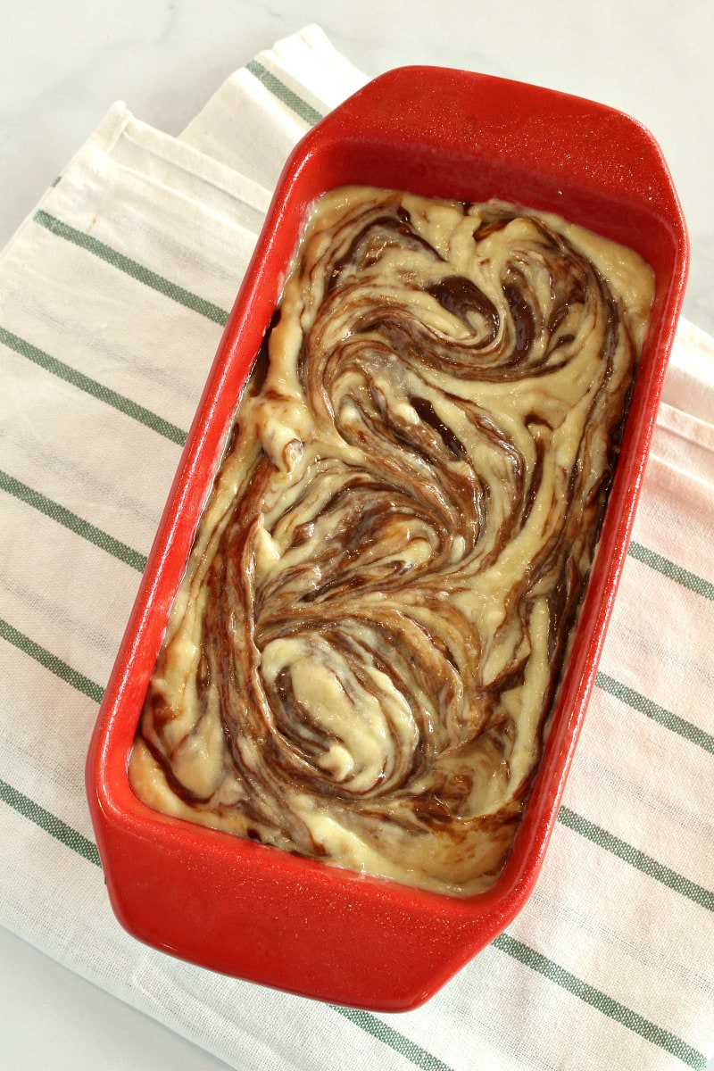 showing the swirl of the batter in a loaf pan for nutella banana bread