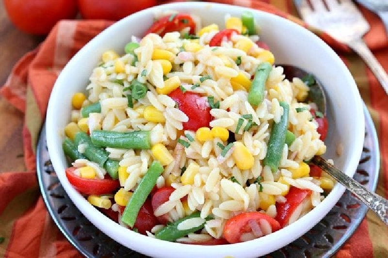 Orzo Salad with Corn, Green Beans and Tomatoes recipe from RecipeGirl.com #orzo #salad #corn #greenbeans #tomatoes #recipe #RecipeGirl white bowl of orzo salad