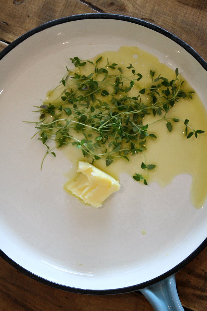 olive oil, butter and fresh thyme in a skillet olive oil, butter and fresh thyme in a skillet