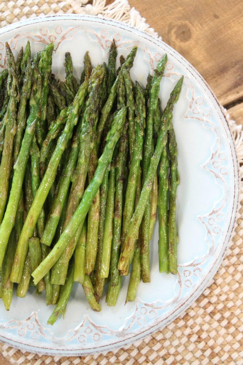 Pan Roasted Asparagus with Thyme recipe from RecipeGirl.com #pan #roasted #panroasted #asparagus #thyme #recipe #RecipeGirl Pan Roasted Asparagus on a serving plate