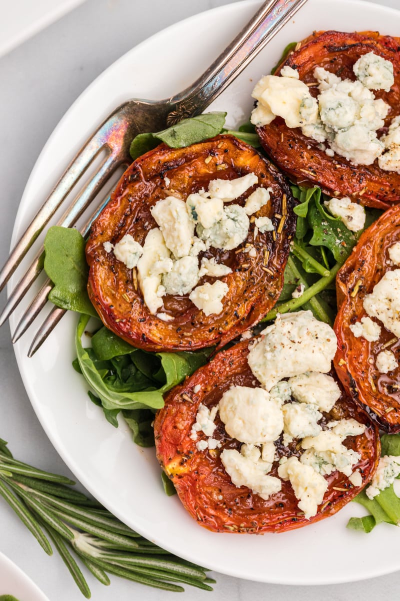 close up roasted tomatoes with stilton on plate