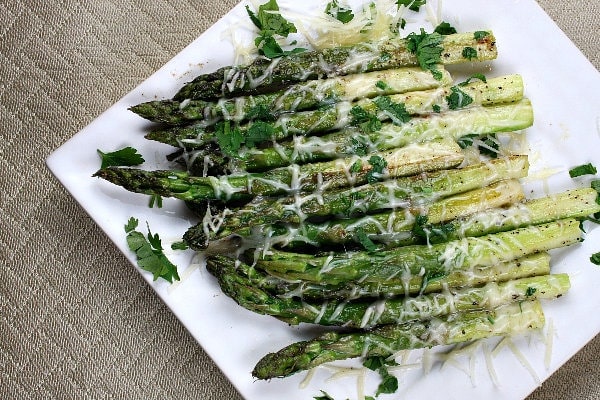 Sauteed Asparagus with Butter and Parmesan Sauteed Asparagus with Butter and Parmesan on white plate