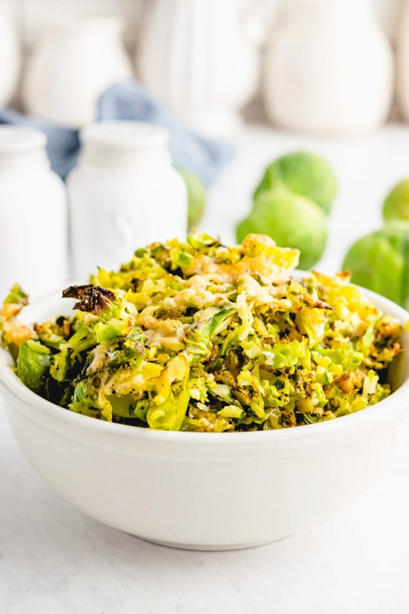 shredded parmesan brussels sprouts in white bowl