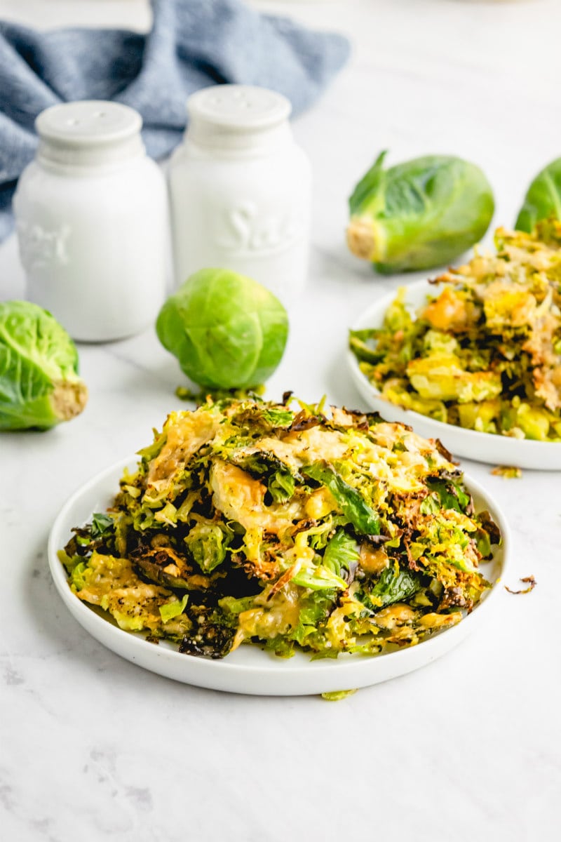 shredded parmesan brussels sprouts on a white plate