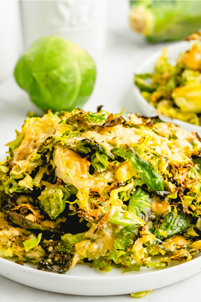 shredded parmesan brussels sprouts on a white plate