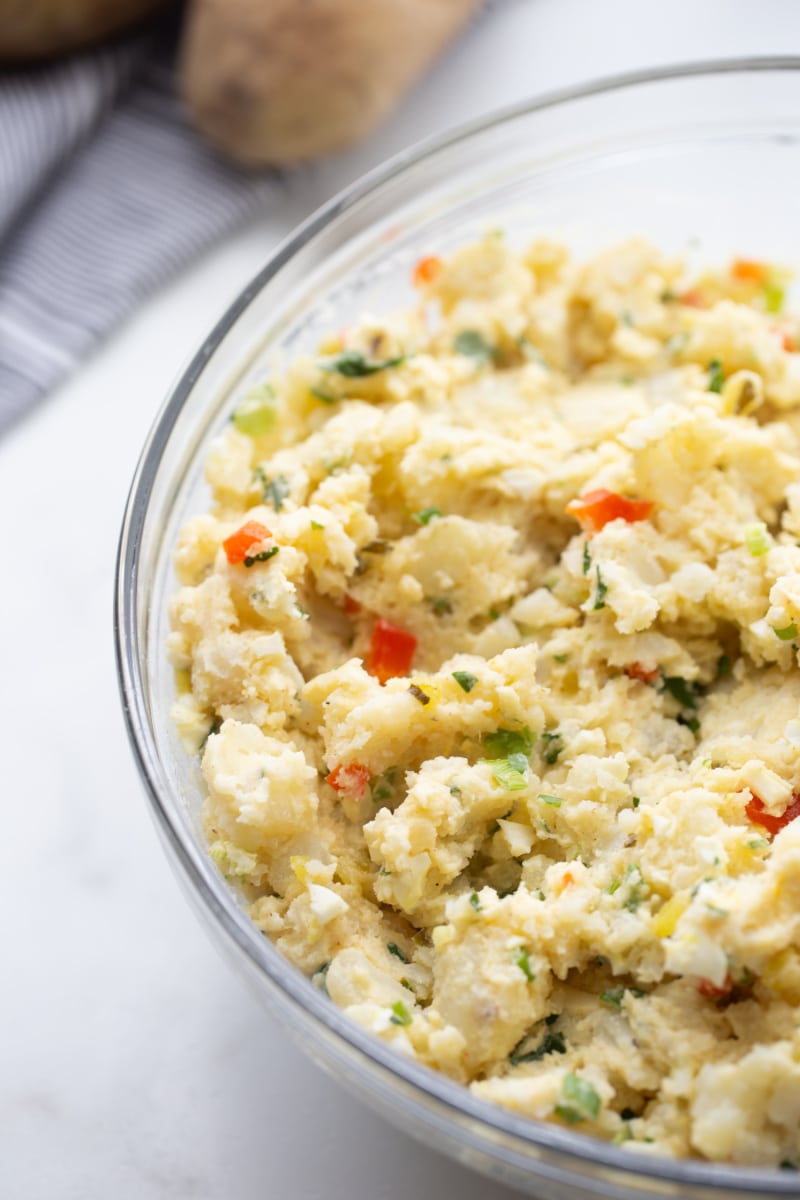 smashed potato salad in a glass bowl