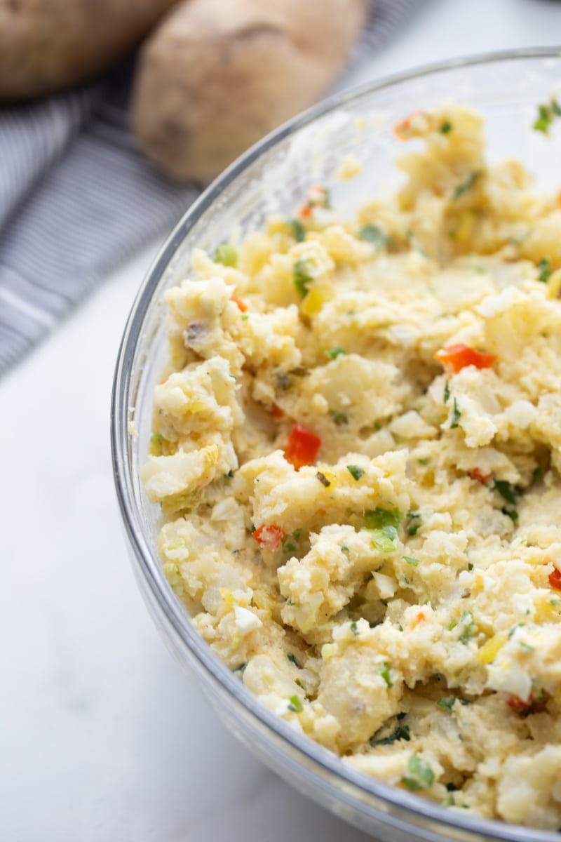 smashed potato salad in a glass bowl