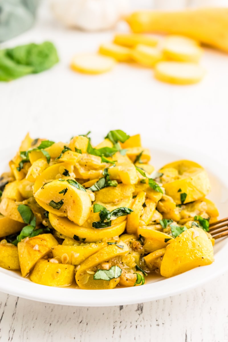 yellow squash and basil on a white plate