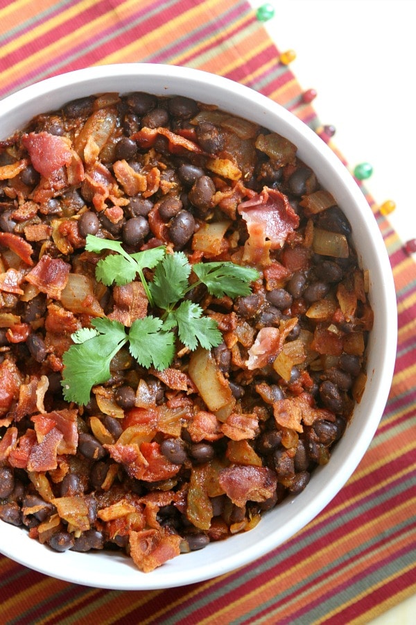 Spicy Black Beans with Onion and Bacon in a white bowl