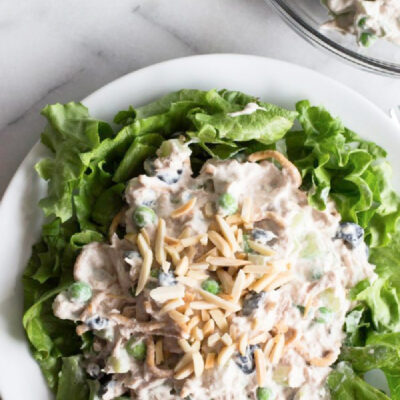 tuna salad on a bed of lettuce on white plate