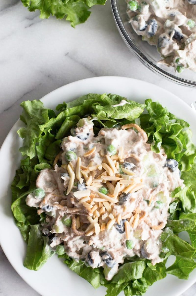 tuna salad on a bed of lettuce on white plate