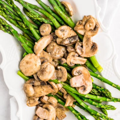 asparagus on a platter with mushroom sauce