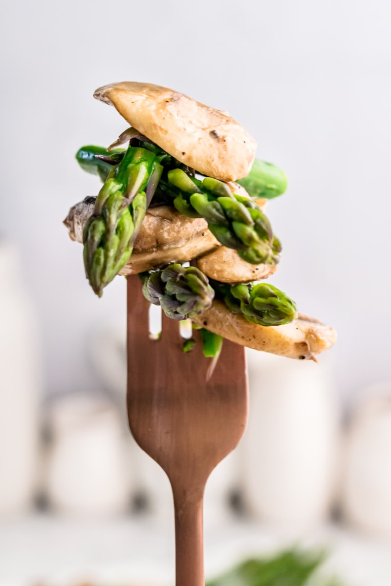 fork full of asparagus and mushrooms