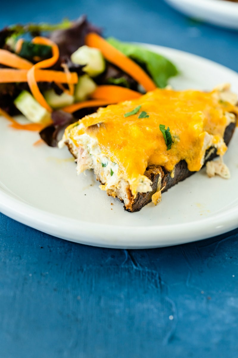 tuna melt on a white plate with salad