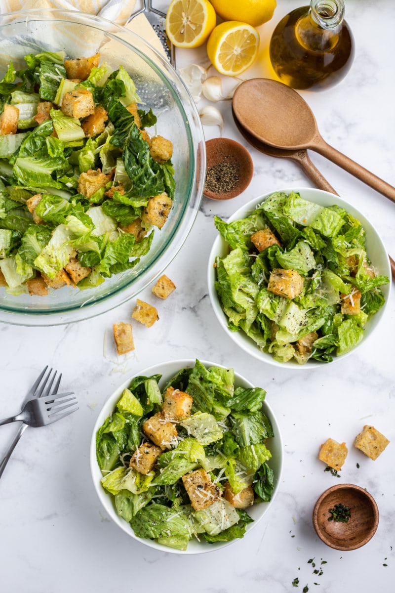 caesar salad with homemade sourdough croutons in bowl and served to two bowls