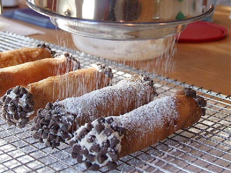 cannoli sprinkled with powdered sugar