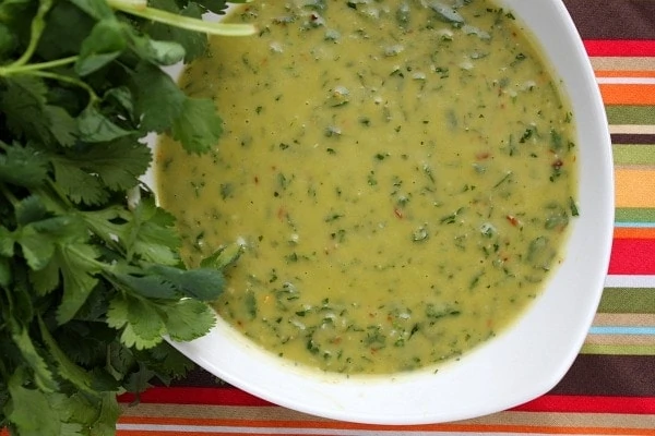 bowl of chimichurri sauce with spoon inside it